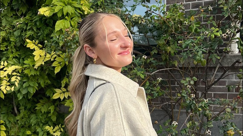 Slicked-back bun with pulled out pieces