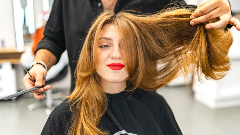 Woman getting a haircut long layers