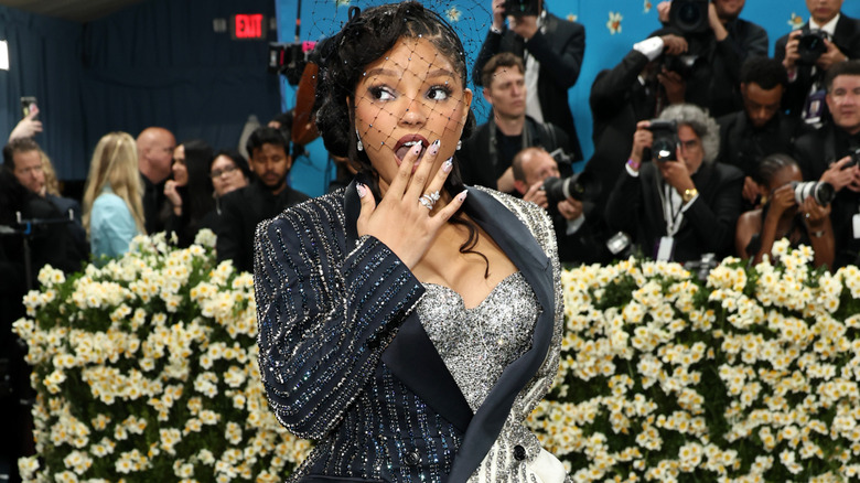 Halle Bailey with a hand over her mouth at the Met Gala