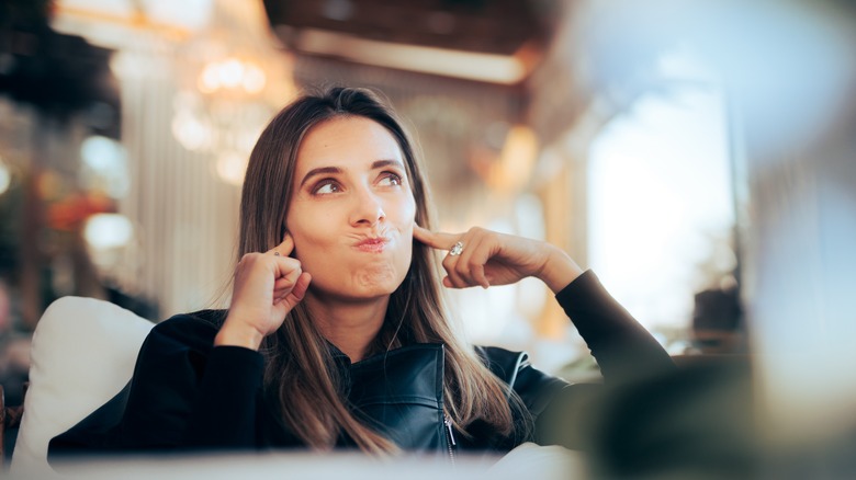 Woman blocking out unwanted noise
