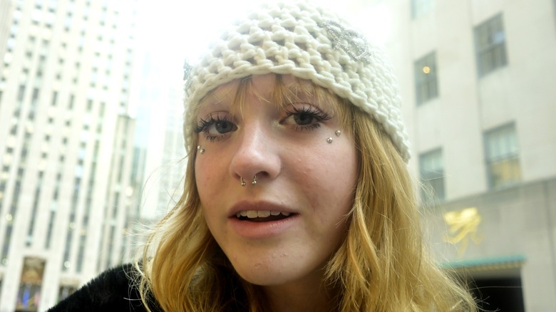 A woman wearing a crochet beanie.
