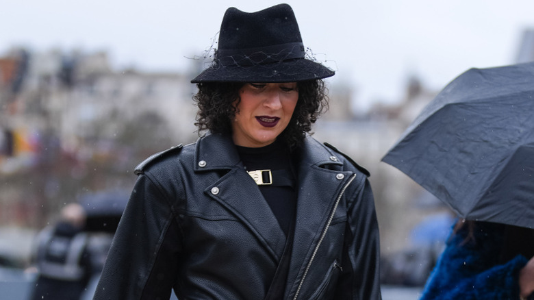 A woman wearing a fedora hat.