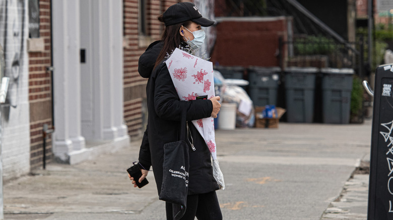A woman wearing a trucker hat.