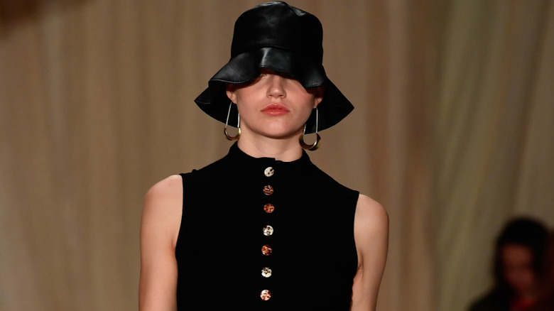 A woman wearing a cloche hat.