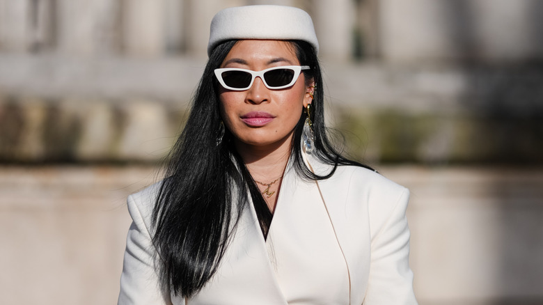 A woman wearing a pillbox hat.