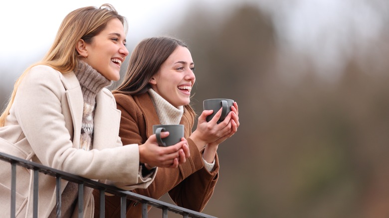 Two girls having tea together