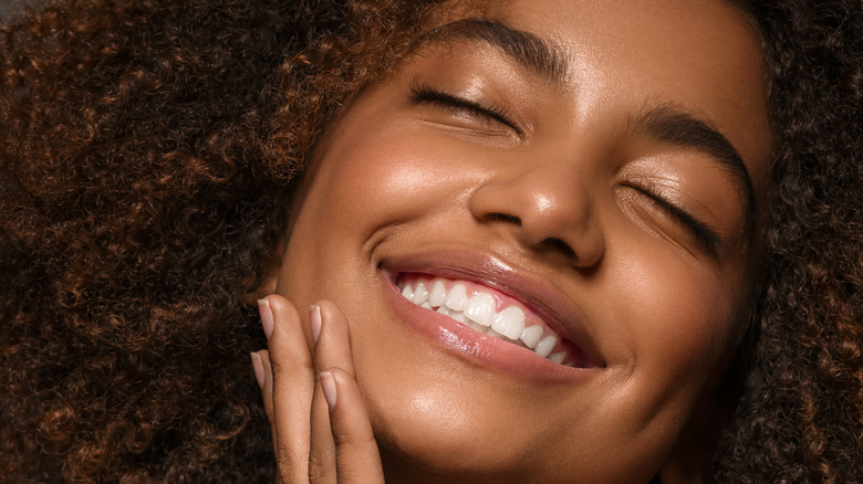 smiling woman with flawless glowing skin