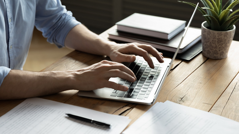 Remote worker close-up of laptop 