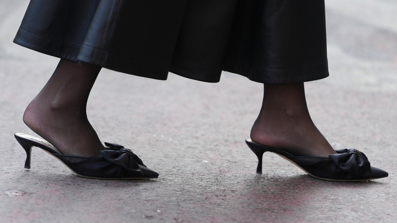 A woman wearing  outdated mules with heels