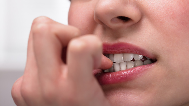 Woman biting nails