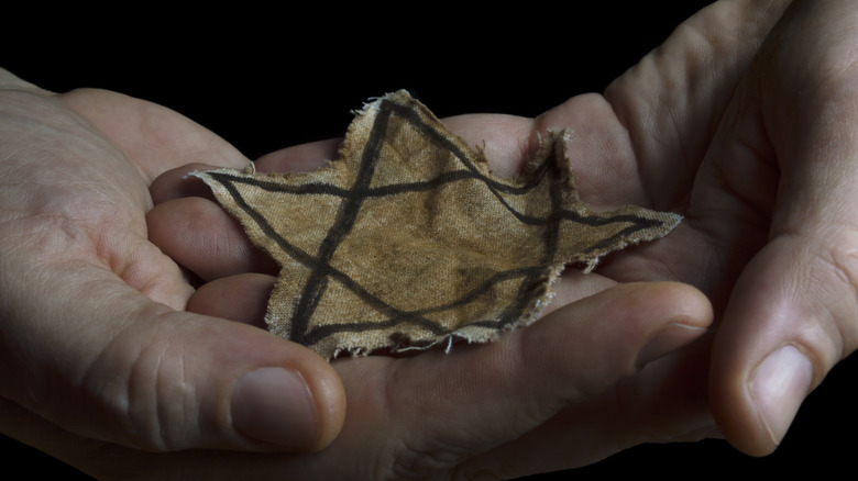 hands holding Star of David