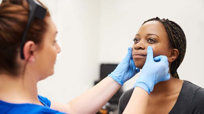 Woman having cosmetic procedure done