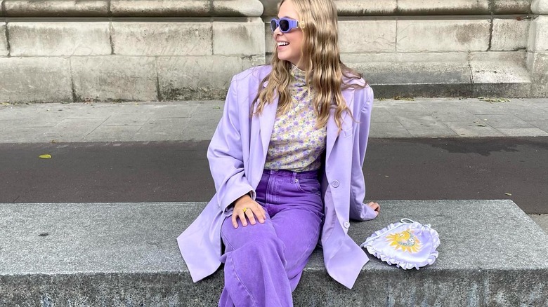 stylish blonde woman wearing purple