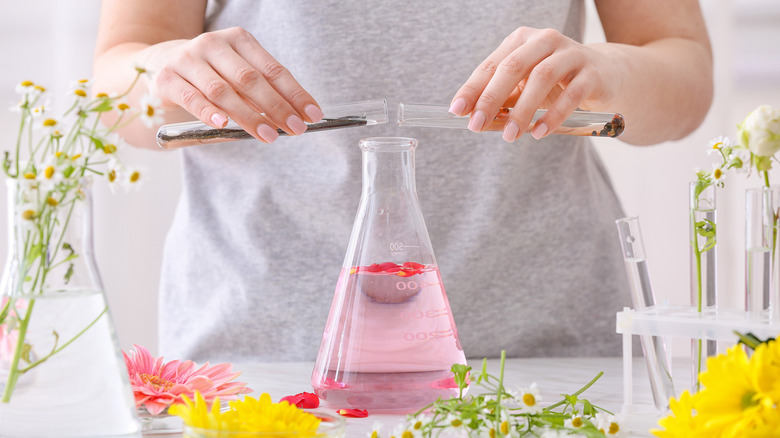 woman making perfume in vials