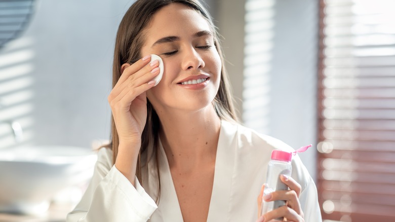 Woman doing skincare in the bathroom