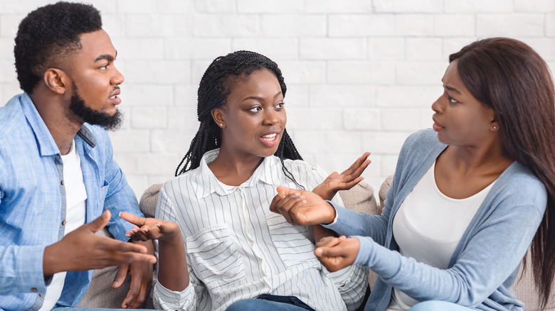 three people arguing