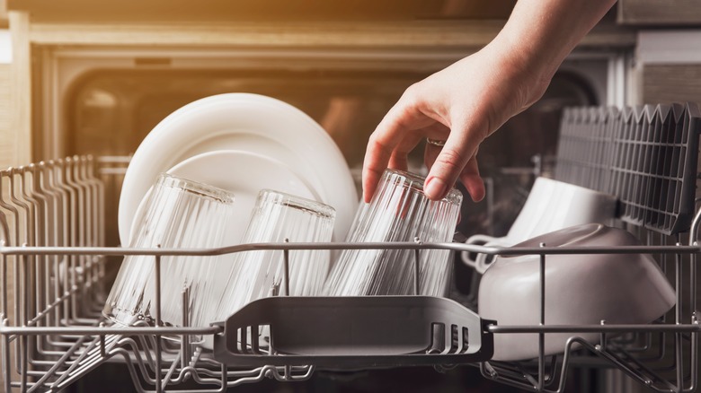 Person putting dishes in the dishwasher