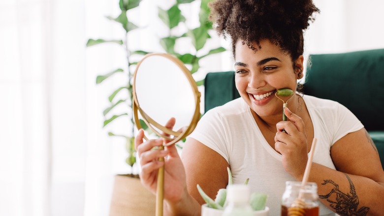 woman using jade roller