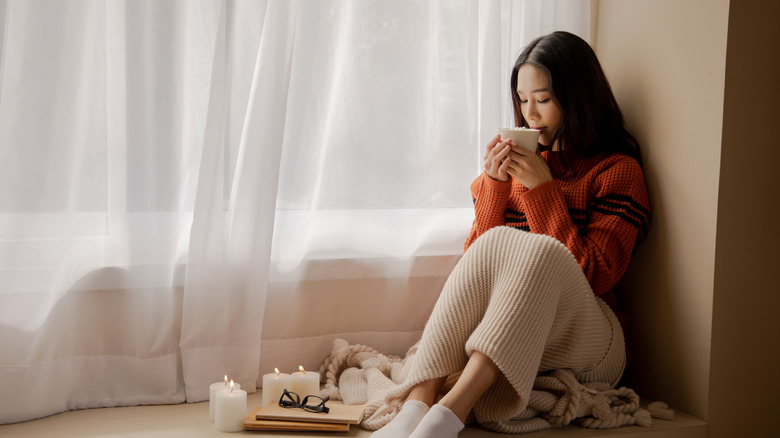 young woman sipping cocoa 