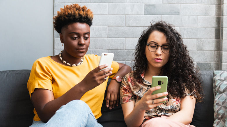 two women using their phones
