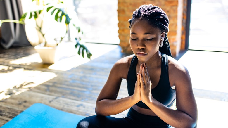 woman meditating in sports bra 
