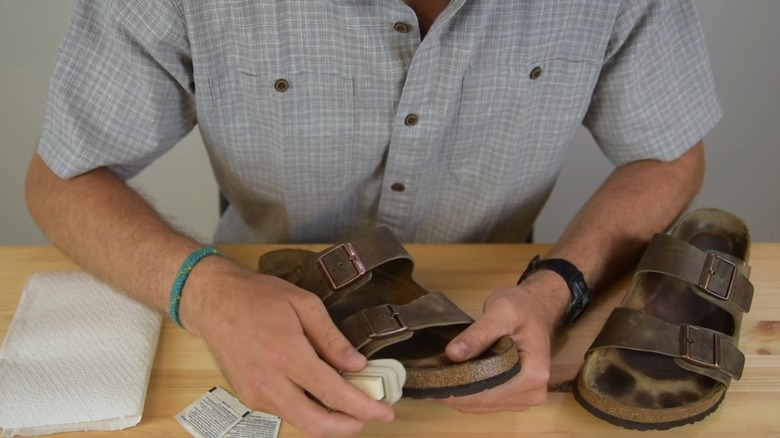 Person brushes Birkenstocks 