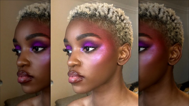 Woman studies face in mirror