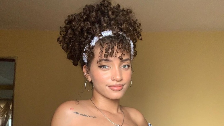 Curly curtain bangs with a headband