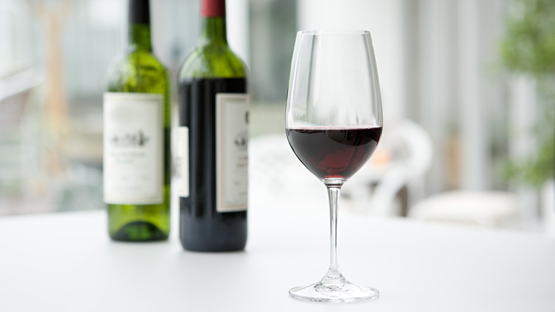 Red wine glass and bottles