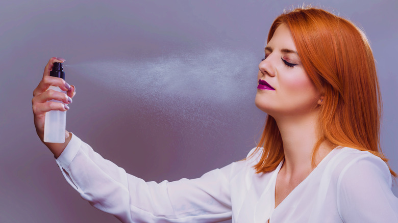 Woman applying setting spray