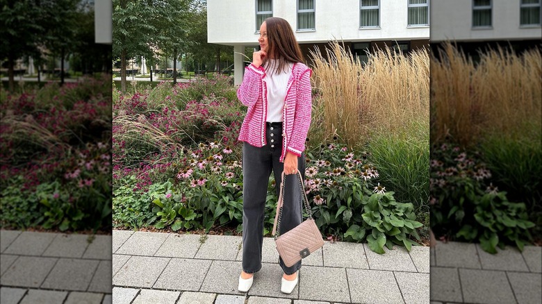Woman wearing preppy accessories with black jeans.