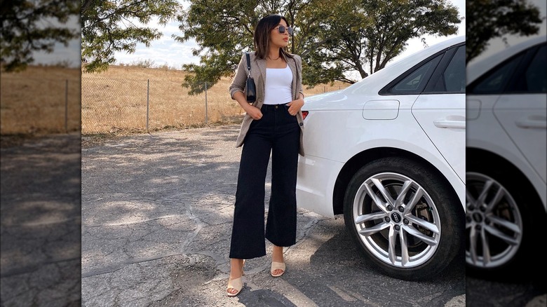 Woman wearing black jeans with a blazer.