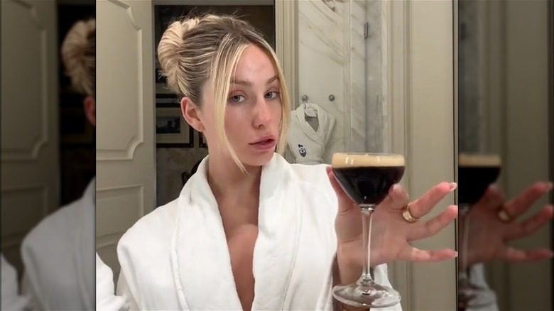 Alix Earle holding espresso martini