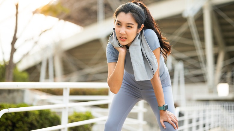 Woman grimaces while attempting run