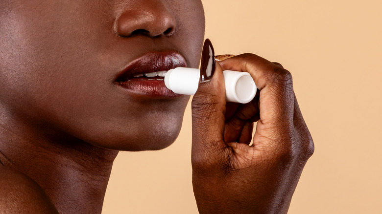woman applying lip balm