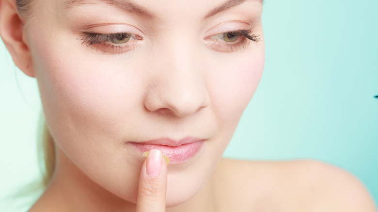 woman applying lip balm 