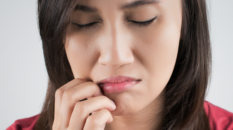 woman scratching mouth