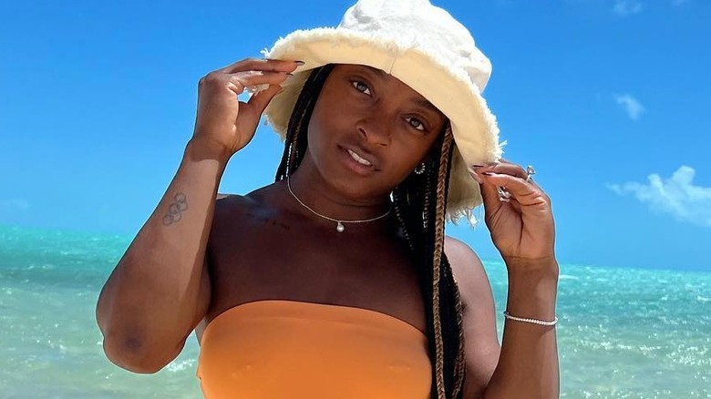 Simone Biles in orange swimsuit