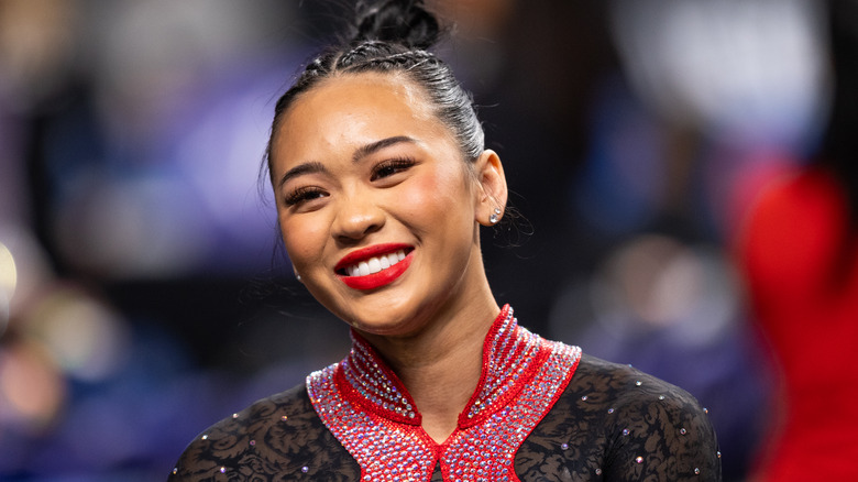 Suni Lee red lipstick braids in hair
