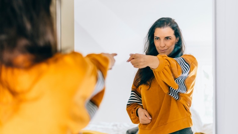 Woman pointing at herself