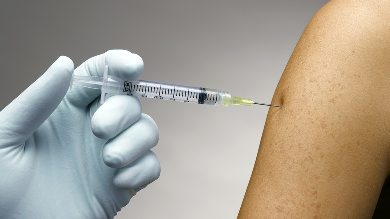 person receiving shot in arm