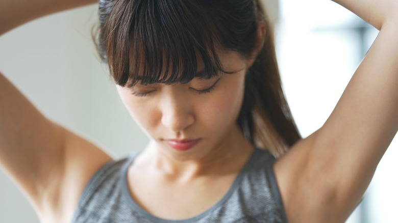 Model adjusting ponytail