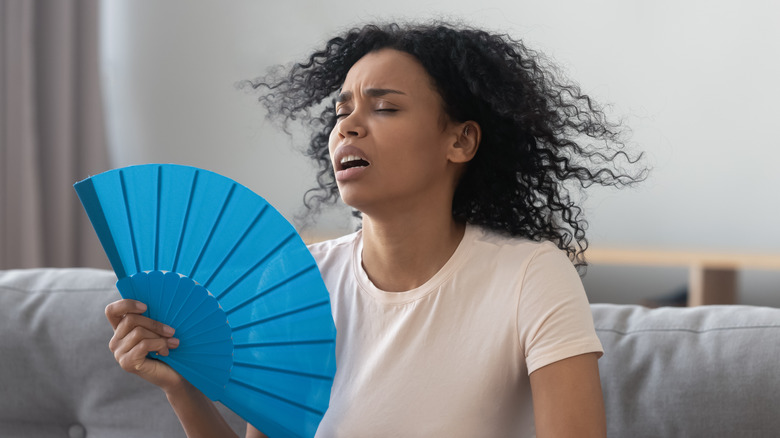 Woman fanning herself
