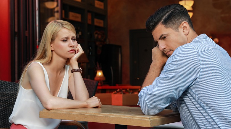 Unhappy people on a bad date