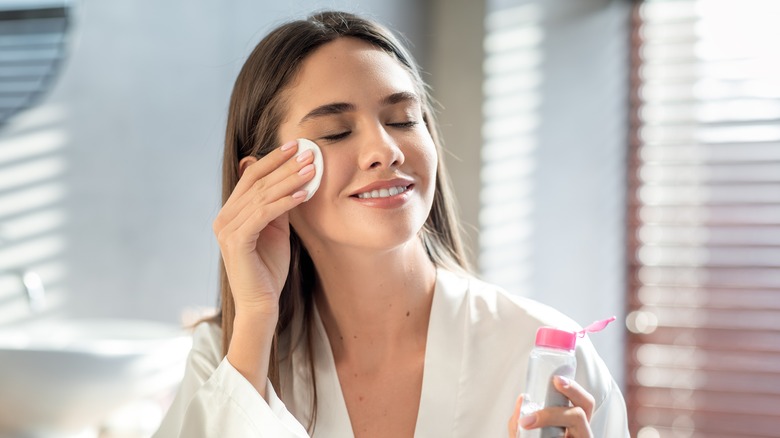 Woman applying skincare product