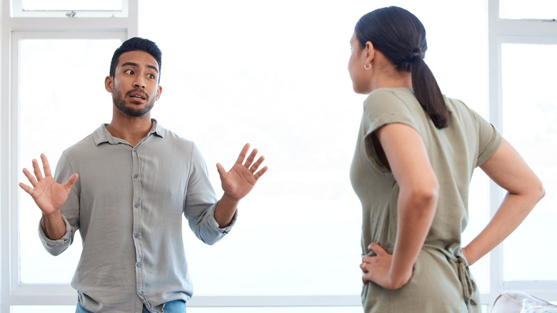 man hands up with woman