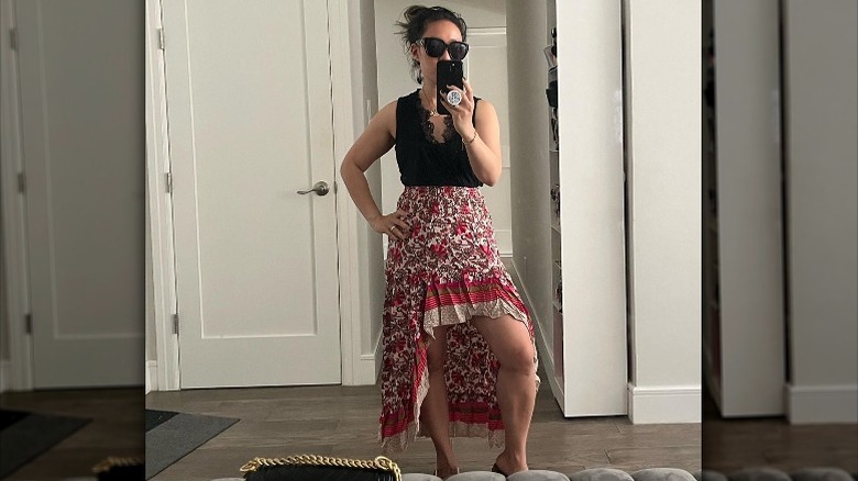 Woman wearing floral high-low skirt