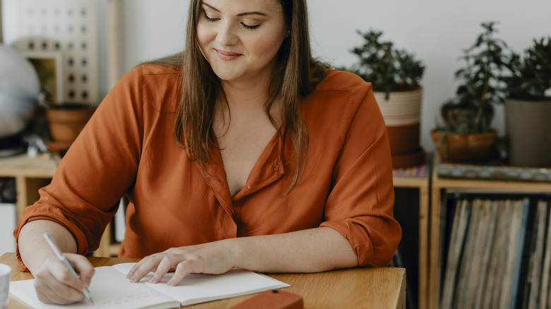 Woman writing in a journal