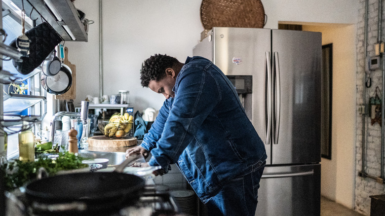 Man slumps over kitchen