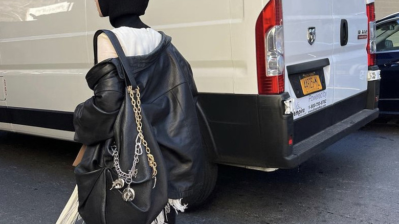 Woman wearing jacket and hobo bag